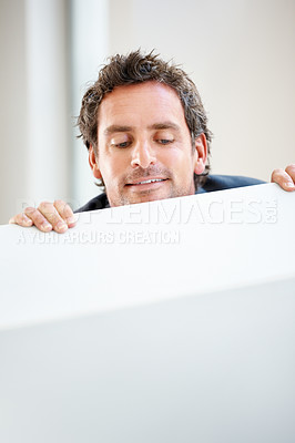 Buy stock photo Middle aged executive looking over the wall