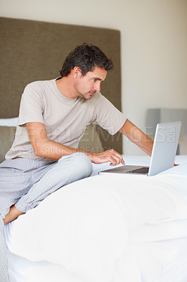 Buy stock photo Working, man in bedroom and laptop to work from home, smiling and sitting in bed for freelance job. Technology, Entrepreneur and remote worker for online job, company and marketing projects

