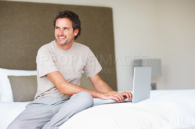 Buy stock photo Working, man in bed and laptop to work from home, thinking and sitting in pyjamas for freelance job. Technology, entrepreneur and remote worker for online,  happiness and marketing projects
