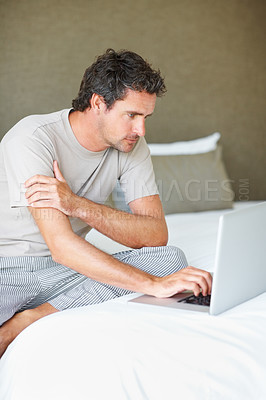 Buy stock photo Freelancer, man in bedroom and laptop to work from home, smiling and sitting in bed for freelance job. Technology, Entrepreneur and remote worker for online job, company and marketing projects

