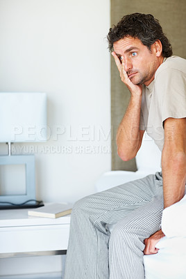 Buy stock photo Headache, wake up and man in bed in the morning, anxiety and frustrated, lonely or mental health crisis in home. Tired, fatigue and person in bedroom stress, insomnia migraine and exhausted in house