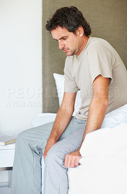 Buy stock photo Thinking, sad and man in bed in depression, anxiety or frustrated, lonely or mental health crisis in home. Tired, fatigue and person in bedroom stress, insomnia challenge and wake up in the morning