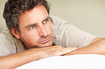 Middle aged man relaxing on bed