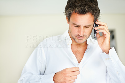 Buy stock photo Phone call, shirt and business man in bedroom getting ready for work, job and career at home. Morning, communication and person dressing clothes button on cellphone for conversation, chat and contact
