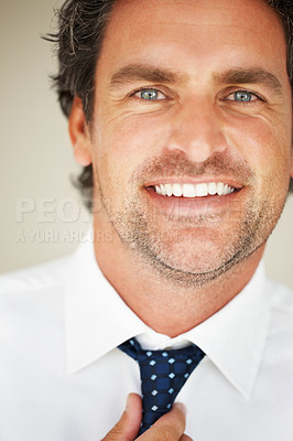 Buy stock photo Man, portrait and tie with smile for dressing, morning routine and formal style for corporate job in studio. Businessman, face and happy with getting ready, confidence and pride on beige background