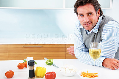 Buy stock photo Portrait of a confident mature man standing in the kitchen
