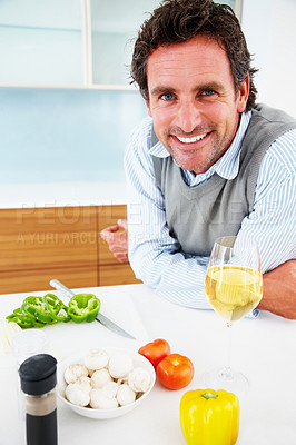 Buy stock photo Portrait, smile and man cooking vegetables with wine for healthy diet, food or nutrition in home. Face, kitchen and happy person meal prep for dinner or organic salad with alcohol drink in Sweden