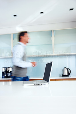 Buy stock photo Kitchen, motion blur and man with laptop, morning rush and speed with professional, creative agency and entrepreneur. Person, employee and graphic designer with computer, deadline and side profile