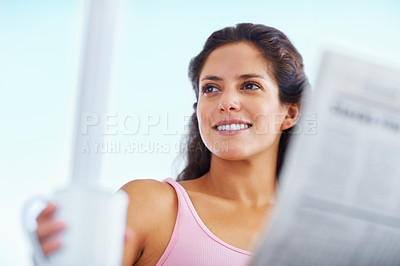 Buy stock photo Happy woman, thinking and newspaper with coffee and morning headlines for wellness in living room. Young person, smile and espresso to relax on weekend and current events with warm drink in apartment