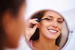 Woman applying mascara