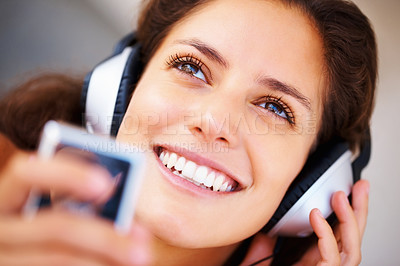 Buy stock photo Smile, headphones and closeup of young woman listening to music, playlist or radio at home. Happy, technology and face of female person from Canada relax and streaming song or album in her apartment.