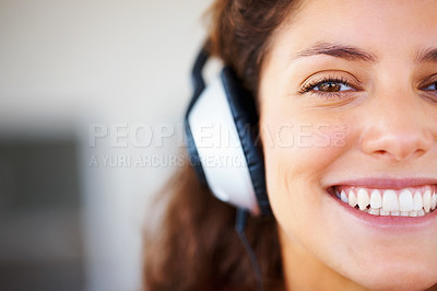 Buy stock photo Smile, headphones and half face of woman listening to music, playlist or radio at home. Happy, technology and portrait of female person from Canada relax and streaming song or album in her apartment.