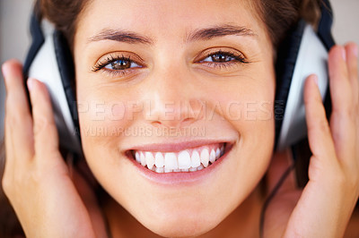 Buy stock photo Smile, headphones and face of young woman listening to music, playlist or radio at home. Happy, technology and closeup of female person from Canada relax and streaming song or album in her apartment.