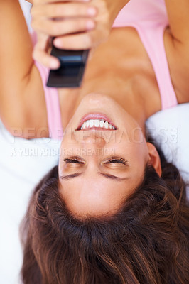 Buy stock photo Top view, smile and woman with phone on bed, social media and relax at home in the morning. Above, happy person on smartphone in bedroom and typing, scroll or communication on internet, mobile or app