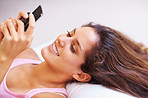 Attractive woman in bed reading SMS