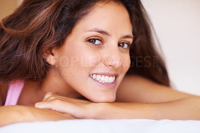 Buy stock photo Smile, portrait and face of young woman relaxing on bed on a weekend morning at modern home. Happy, beautiful and female person with positive, good and confident attitude in bedroom at house.