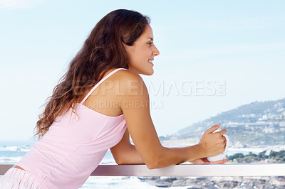 Buy stock photo Happy, balcony and woman with coffee by ocean for summer holiday, vacation and weekend. Travel, hotel resort and person with warm drink for adventure, relaxing and freedom with scenic view of nature