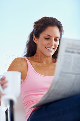 Buy stock photo Happy woman, morning and newspaper with coffee and reading headlines with wellness in living room. Young person, smile and espresso with relax on weekend and current events with warm cup outdoor