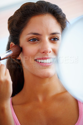 Buy stock photo Woman, face and makeup brush with smile for beauty, cosmetics and facial skincare with mirror in home. Person, happy and glow application with product and hand for wellness, cosmetology and aesthetic