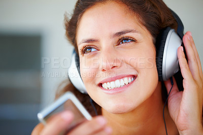 Buy stock photo Happy, headphones and closeup of young woman listening to music, playlist or radio at home. Smile, technology and face of female person from Canada relax and streaming song or album in her apartment.