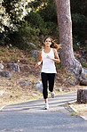 Attractive woman jogging on pathway