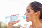 Young woman drinking bottled water