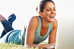 Cute woman on grass with laptop