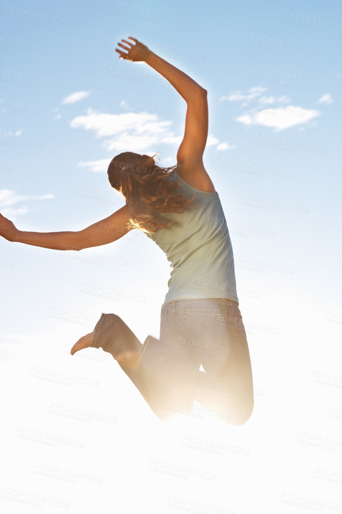 Buy stock photo Back, happy woman and jump in nature for freedom, excitement and joy in sunshine. Female person, energy and arms up for success, achievement and celebrate outdoors in natural sunlight with bare feet