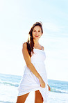 Happy young female standing by the sea