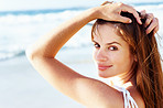 Pretty young female posing on the beach