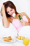 Happy romantic female with breakfast in bed