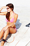 Beautiful young woman looking away at beach