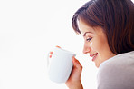 Closeup side view of a smiling female drinking a cup of coffee