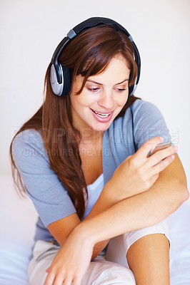 Buy stock photo Headphone, music player or bedroom woman listen to playlist track, audio podcast or wellness sound. Relax morning, home bed or girl reading, search or streaming stress relief song, media or radio app