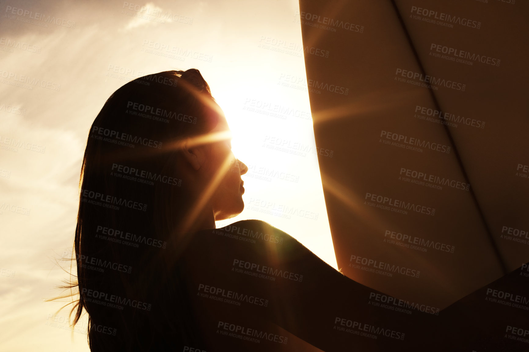 Buy stock photo Woman, surfboard and sunlight in summer or nature, ocean or water sports or surfing. Sunset, clouds or beach for silhouette for female person, vacation and travel for exercise or health and wellness 
