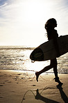 Pretty young female surfer with her surfboard