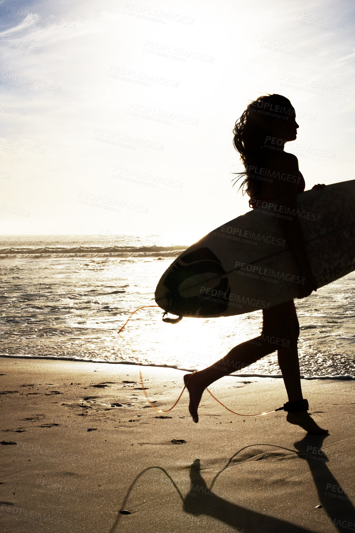 Buy stock photo Woman, silhouette and sunset with ocean for surfer with fitness, outdoor and training at sea. Running, waves and sand on beach coast for surfing on summer vacation, sky and water sports with shadow