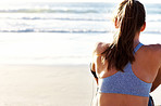 Young woman sitting on the sea shore - Outdoor