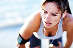 Tired young female taking breath after jogging