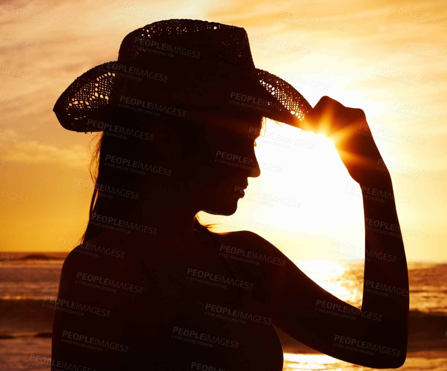 Buy stock photo Silhouette, hat and woman by sunset in ocean for vacation, holiday and adventure in Puerto Rico. Scenic view, harmony and girl with orange sky for peace, relax and summer break on beach for wellness