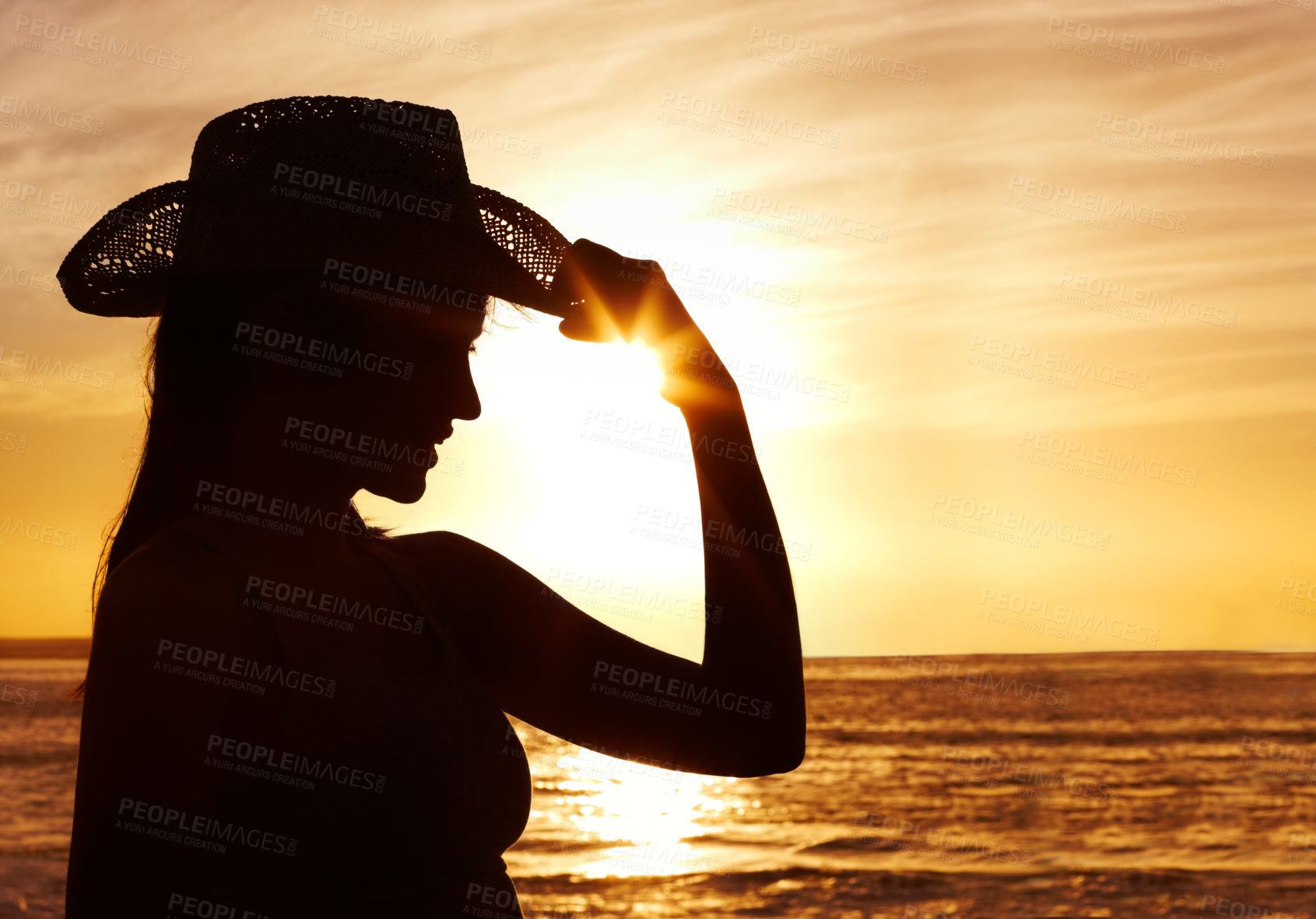 Buy stock photo Silhouette, hat and woman by sunset on beach for vacation, holiday and adventure in Puerto Rico. Scenic view, harmony and girl with orange sky for peace, relax and summer break in ocean for wellness