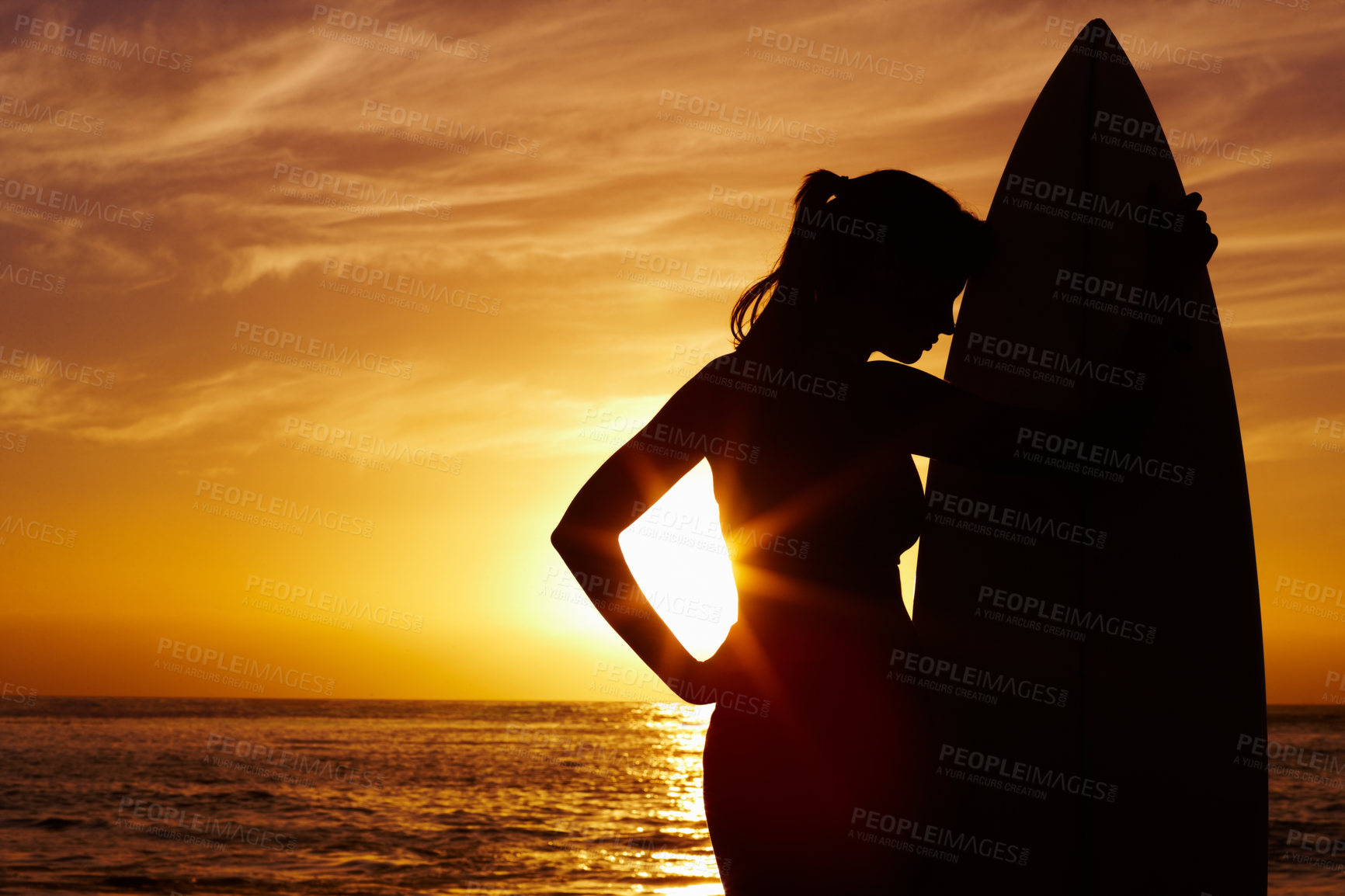 Buy stock photo Silhouette, sunset and woman surfer at ocean for outdoor training, vacation and holiday. Summer, waves and shadow of beach coast for health, surfing and lens flare with dark surfboard in nature 