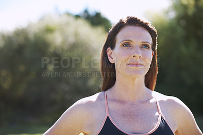 Buy stock photo A thoughtful-looking woman in sports clothing standing in the outdoors