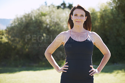 Buy stock photo An attractive woman in sports clothing standing with her hands on her hips in the outdoors