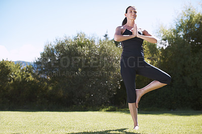 Buy stock photo Full-length shot of an attractive woman practicing yoga