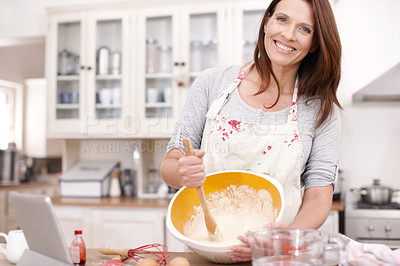 Buy stock photo Portrait of a mature woman baking in the kitchen with copyspace