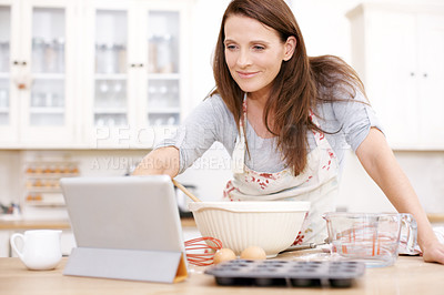 Buy stock photo Baking, woman and tablet with bowl at kitchen counter for ingredients, recipe or instruction on cake in home. Online, browsing internet and happy person with apron for dessert, cookies or cupcakes