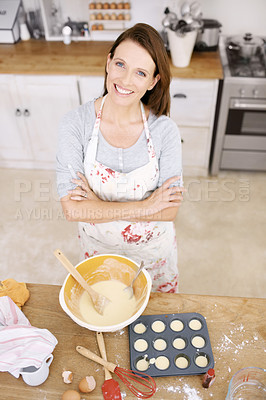 Buy stock photo Portrait of a confident and mature woman baking in the kitchen
