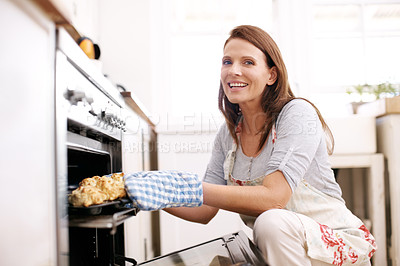 Buy stock photo Woman, smile and portrait by oven in kitchen for baking scones or handmade pastry, dessert and snack for eating. Girl, home and cook with apron for brunch or relax, hobby and sweet food for comfort.