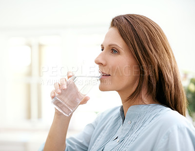 Buy stock photo Home, thinking and woman with drinking water in glass for hydration, minerals and liquid nutrition. Female person, thirsty and smile with aqua in kitchen for healthy diet, wellness and h2o detox